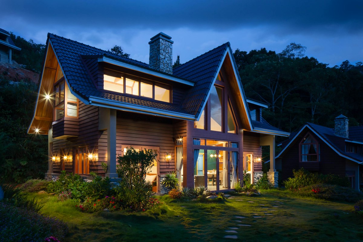 Two-story home exterior lit up at dusk